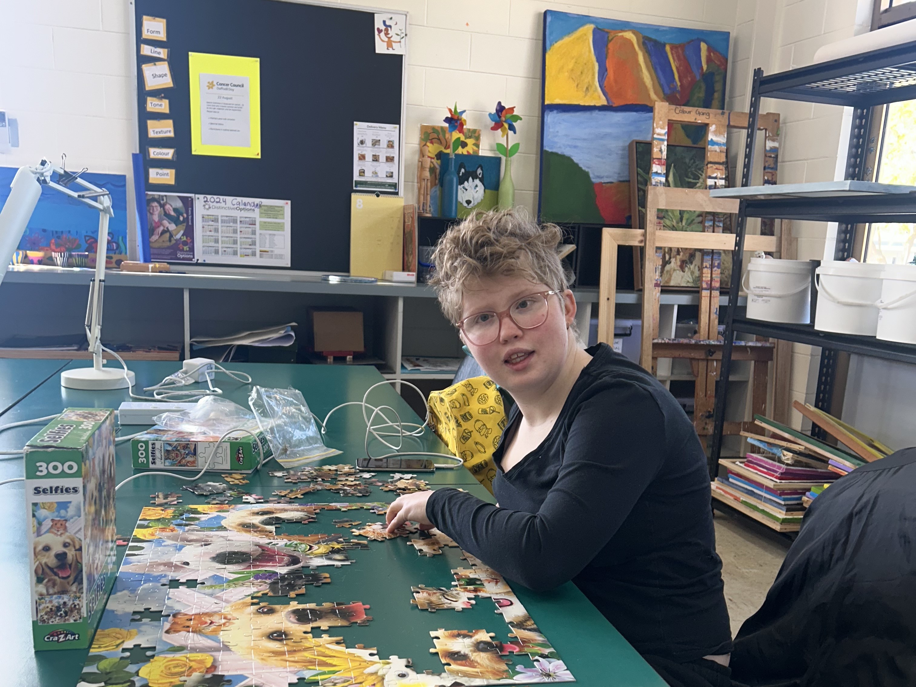 Lady doing a large jigsaw at Distinctive Options Noweyung Bairnsdale