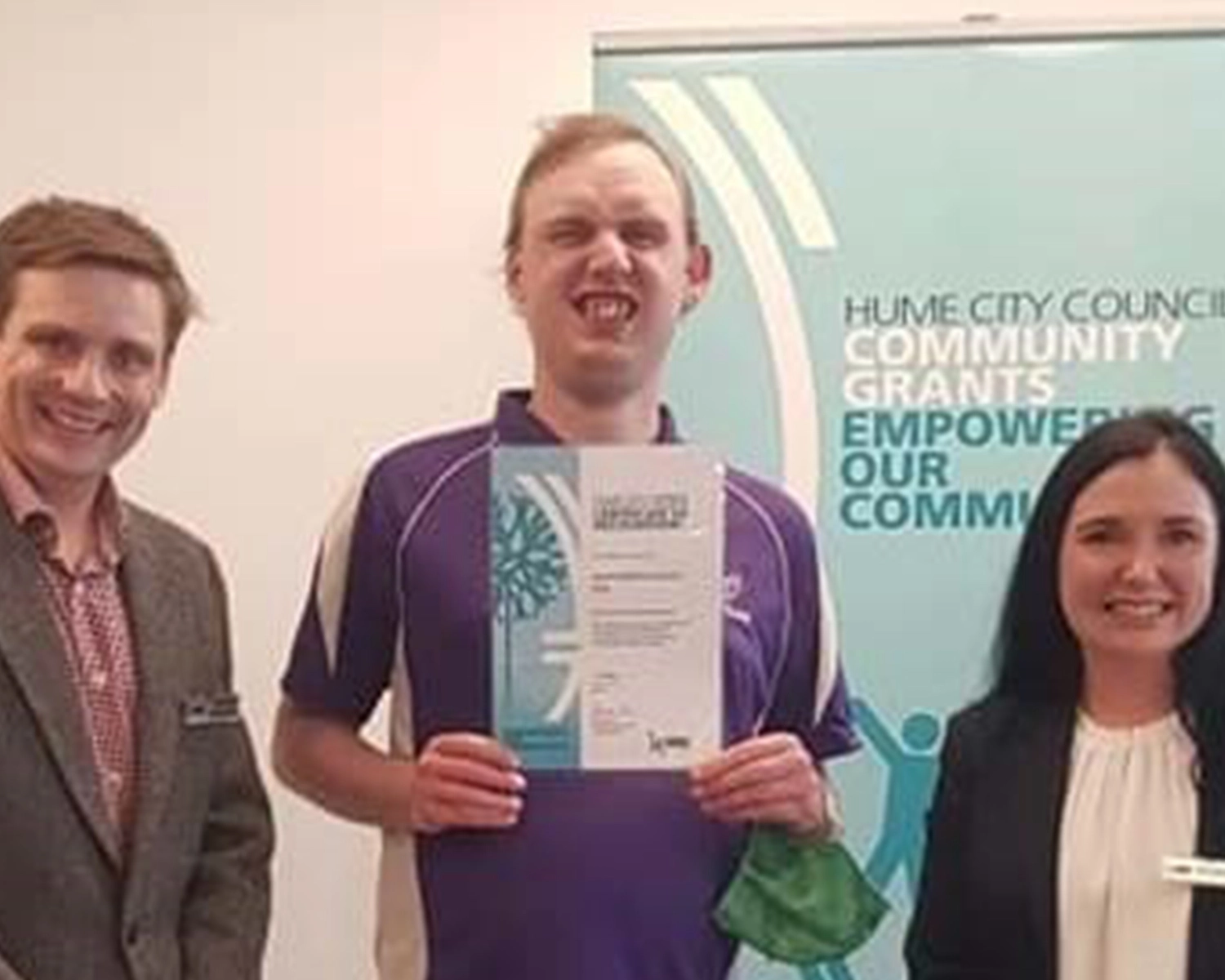 Three people stand in a group dressed in corporate clothing at NDIS registered disability service Distinctive Options