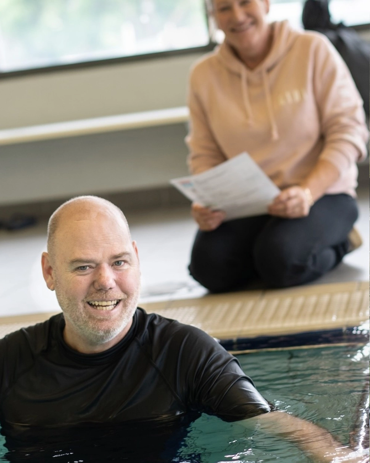 A man stands in a pool at Independent living supports NDIS registered disability service Distinctive Options