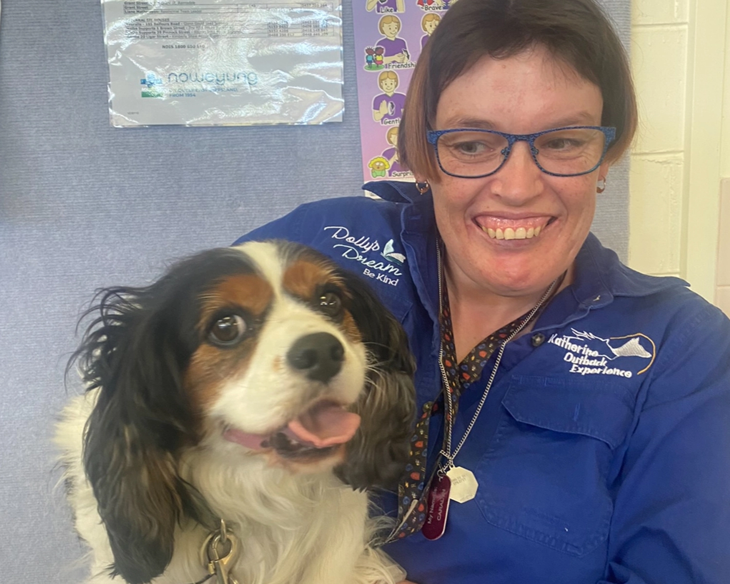 A woman smiles with a dog on her lap at Pets and pet care at Distinctive Options Noweyung