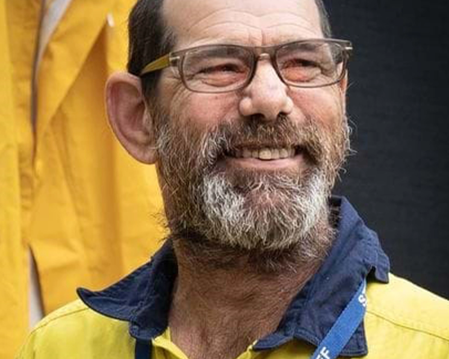 A man with a beard wears a high vis vest at NDIS registered disability service Distinctive Options
