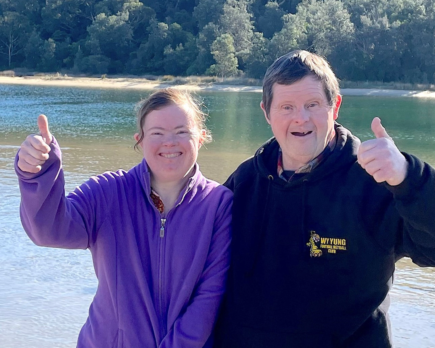 Two people stand by a river at NDIS registered disability service Distinctive Options Supported accommodation