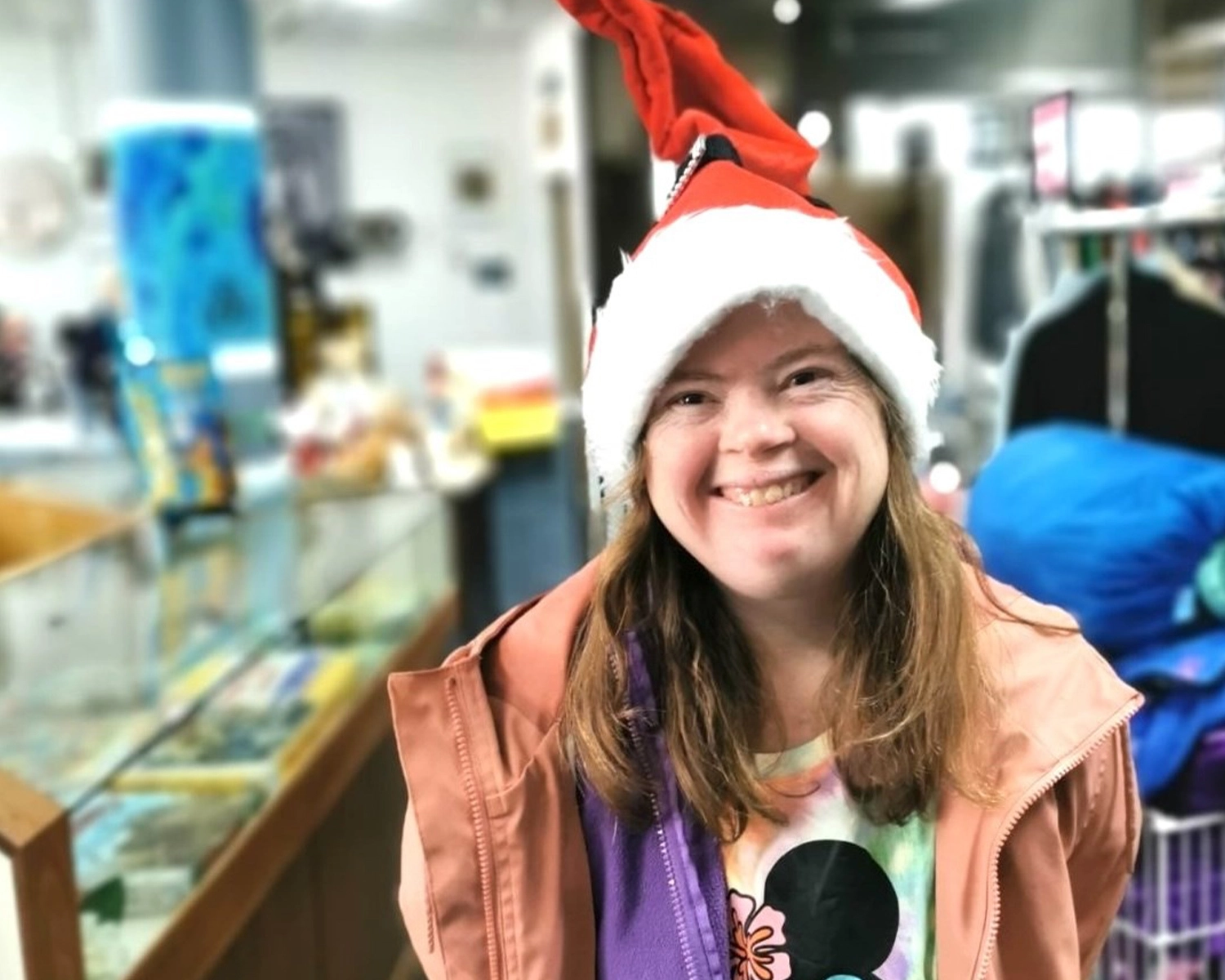 A woman smiles while in a shop for Group Supports Volunteering and Community Engagement at Distinctive Options Noweyung