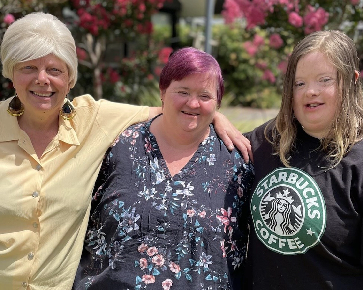 Three women stand together for Group Supports Women's Wellness at Distinctive Options Noweyung