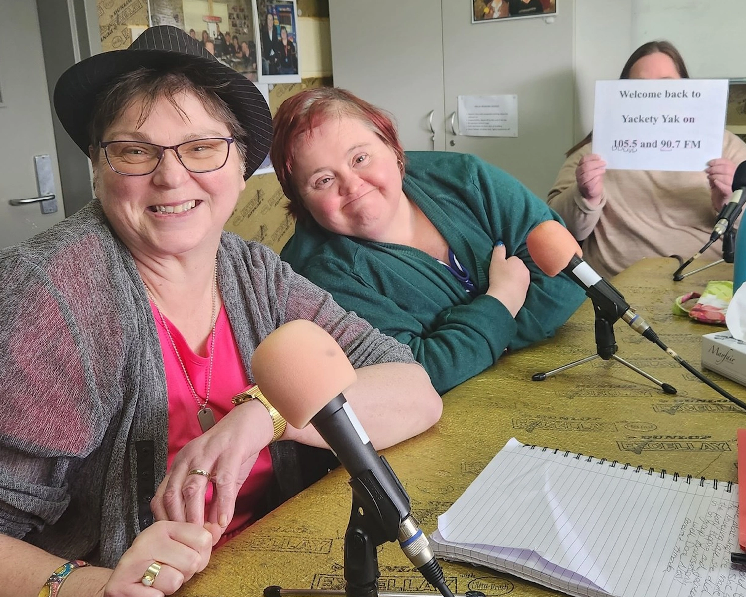 Two women in a radio studio, smiling at Group Supports Yackety Yak radio show at Distinctive Options Noweyung